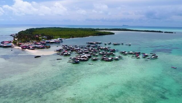 Pull away aerial shot of a Bajau Laut sea nomad community at Pulau Omodal, Sabah, Malaysia