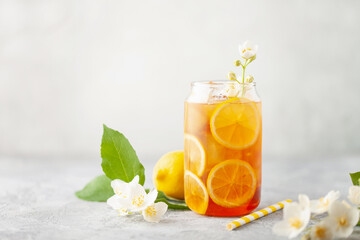 Lemon jasmine iced tea in a glass  on a gray background