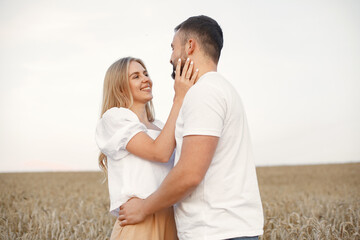 Beautiful couple spend time in a autumn field