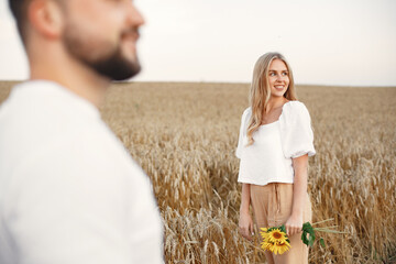 Beautiful couple spend time in a autumn field