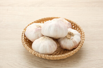 Fresh garlic (bawang putih) on a wooden table
