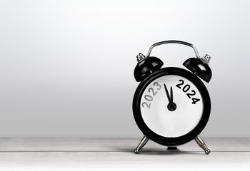 Black alarm clock on with number year. New year concept.