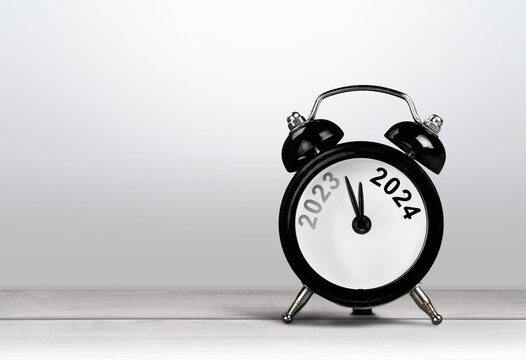 Black alarm clock on with number year. New year concept.