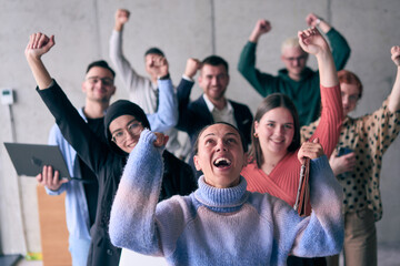 A diverse group of successful businessmen raises their hands in the air, symbolizing achievement, accomplishment, and the fulfillment of goals, exuding confidence, unity, and celebration of their