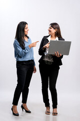 Two Young indian businesswoman watching some detail in laptop.