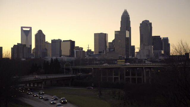 Lockdown Shot Of Vehicles Moving On Road And Bridge In City At Sunset - Charlotte, North Carolina