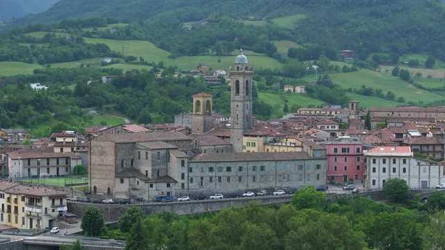 Bobbio village with cathedral bell tower, Piacenza in Italy. Aerial ascending