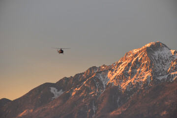 Helicopter fliying over Mount Storzic in Slovenia