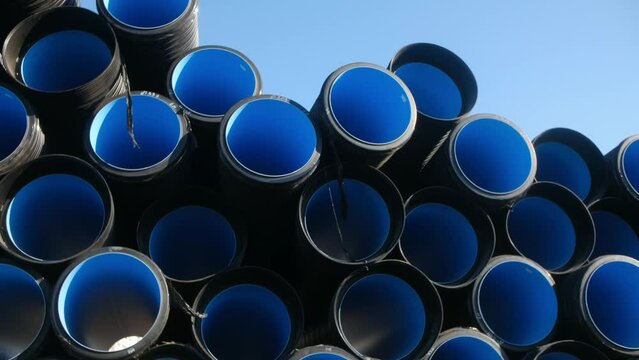 Double-layer corrugated pipes made of low-pressure polyethylene for external sewerage. Sewage system. A lot of pipes in front of the construction site.