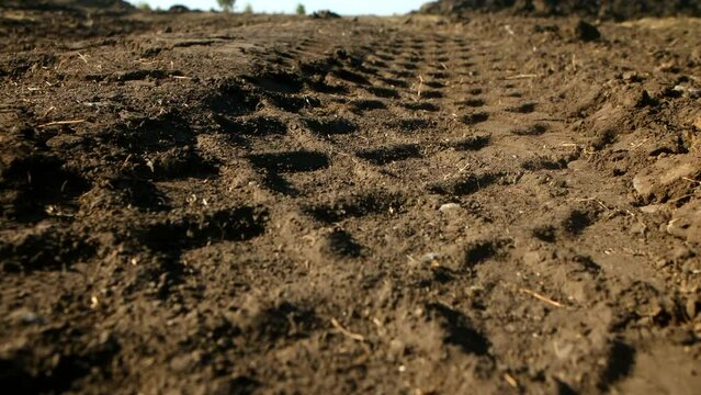 the tracks of the wheels of a large truck on a dirt road. wheel tracks on ground road. High quality 4k footage. close up. 