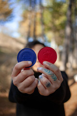 Hands of person woman holding biomagnetism magnets in the forest. Hands of young woman holding...