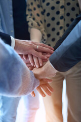 A top view photo of group of businessmen holding hands together to symbolize unity and strength