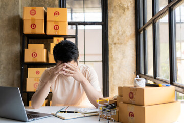 Fed up with unhappy and stressed businessman, Asian man started SME business owner at cardboard box...