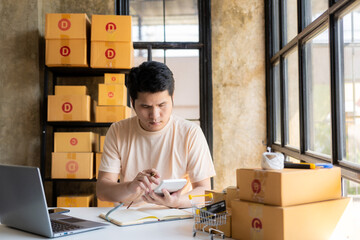 Young asian sme businessman working at warehouse, home office, independent courier company with...