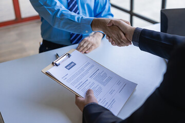 handshake during job interview Male candidate shaking hands with interviewer or employer after job...