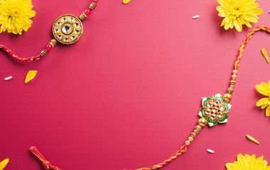 Raksha Bandhan, Indian festival with beautiful Rakhi, Rice Grains and flower. A traditional Indian wrist band which is a symbol of love between Sisters and Brothers