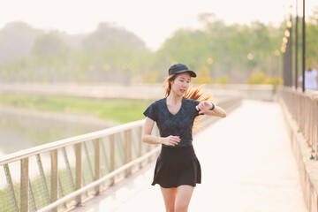 young woman relax in garden road evening ,woman fitness silhouette sunrise jogging workout wellness concept.	