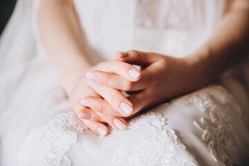 Wedding. A bride in a white dress sits with her arms folded