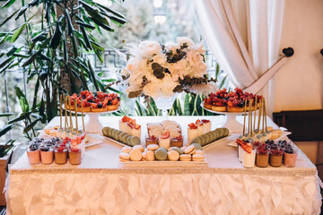 Catering. Food. Wedding. Candy bar. Cakes and sweets on the buffet table at the restaurant