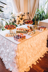 Catering. Food. Wedding. Candy bar. Cakes and sweets on the buffet table at the restaurant