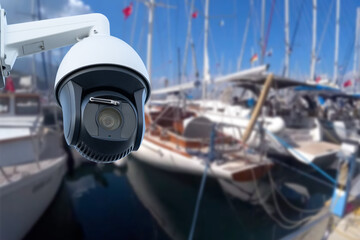 Pair of outdoor security cameras in yachting harbor.