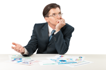 Young businessman sitting at desk and looking in chart
