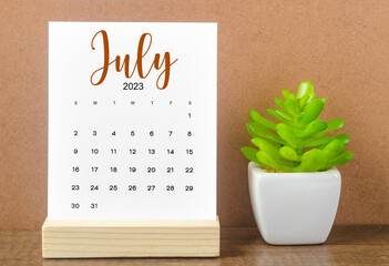 The July 2023 Monthly calendar for 2023 year on wooden table.