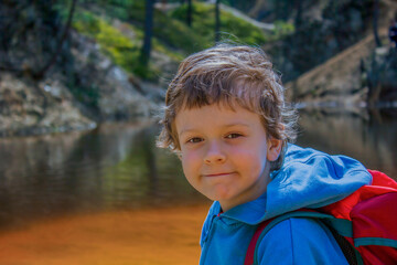 Portrait of a little boy against the background of a mountain lake © Галя Дорожинська