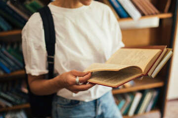 A student stuying and reading books in a public library.