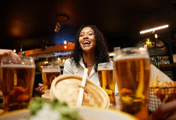 Close-up of happy young multiracial group of friends in casual clothing having dinner at bar