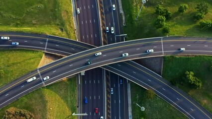Highway, traffic and fast cars with drone and road and aerial urban area. Journey, driving and city traveling outdoor with speed and transportation roads in a car on busy street with vehicle