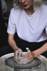 ceramist works behind a potter's wheel
