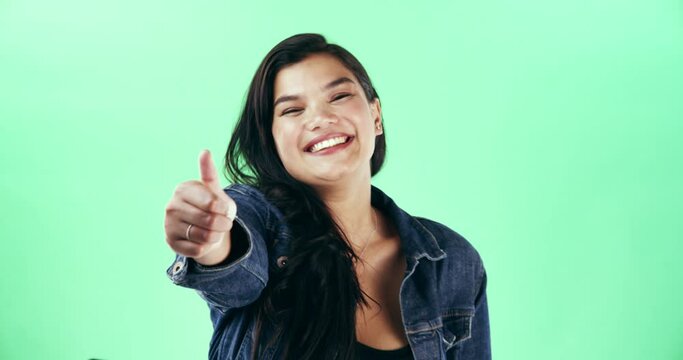 Happy, face and woman with thumbs up on green screen in studio isolated on a background mockup. Portrait, hand gesture and female person with like emoji for agreement, success and thank you for vote.