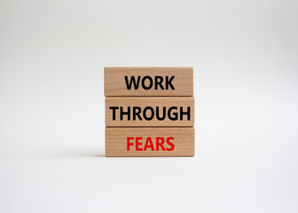 Work through fears symbol. Wooden blocks with words Work through fears. Beautiful white background. Business and Work through fears concept. Copy space.