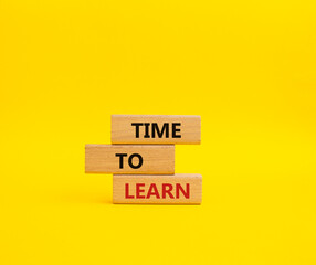 Time to learn symbol. Wooden blocks with words Time to learn. Beautiful yellow background. Business and Time to learn concept. Copy space.