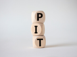 PIT - Personal Income Tax symbol. Wooden cubes with words PIT. Beautiful white background. Business and PIT concept. Copy space.