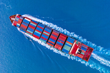 Aerial view ontainer ship in export and import business and logistics. Shipping cargo to harbor.