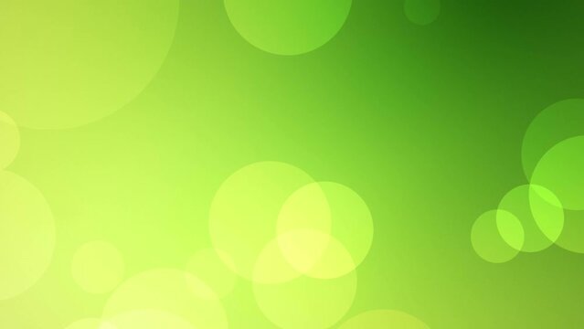 Looped animated green abstract background of floating defocused particles