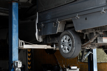 The car was lifted for change old brake car disc rotor, service new part vehicle and maintenance at the garage