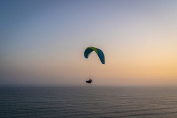 Paragliding during the Sunset in la Costa Verde (Green Coast) in Lima, Peru - 610662278