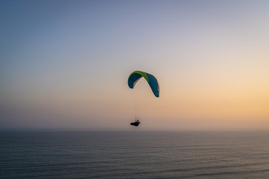 Paragliding during the Sunset in la Costa Verde (Green Coast) in Lima, Peru