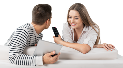 Smiling Couple Using Remote Control and Tablet