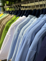 Fototapeta premium Shirts hanging on a hanger. Style and wardrobe for men. Shopping.