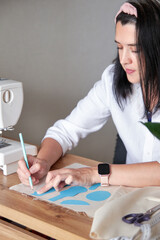 Creative woman working on sewing patterns. - 610673864