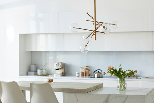 Horizontal image of white bright kitchen with modern design