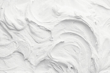 Decorative white putty background. Wall texture with filler paste applied with spatula, chaotic dashes and strokes over plaster.