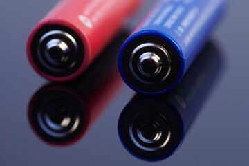 Colorful alkaline AAA batteries close-up isolated on dark background