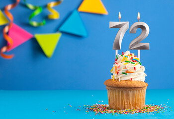 Birthday cake with candle number 72 - Blue background
