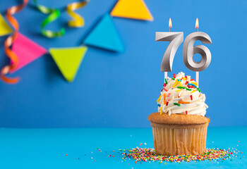 Birthday cake with candle number 76 - Blue background