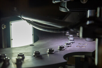 The quality control process of metal screw production line. - obrazy, fototapety, plakaty